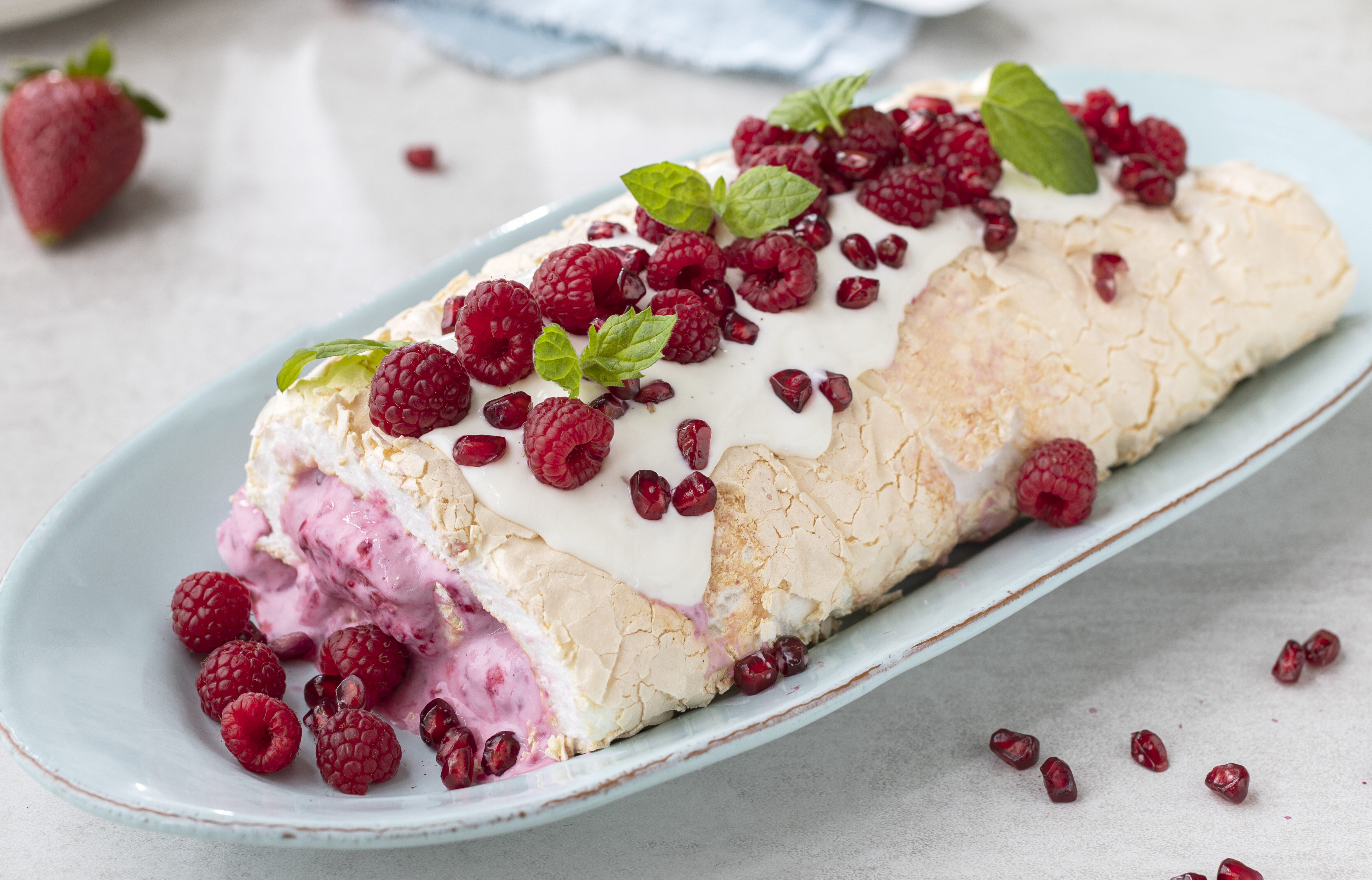 Pavlova rullekake med granateple og bringebær